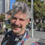 Photo of Adam Scott smiling outside in the Yerba Buena Gardens in San Francisco.